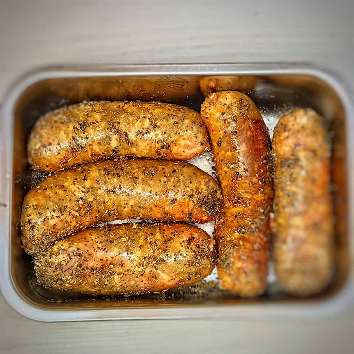 coat italian sausage with oil and seasoning