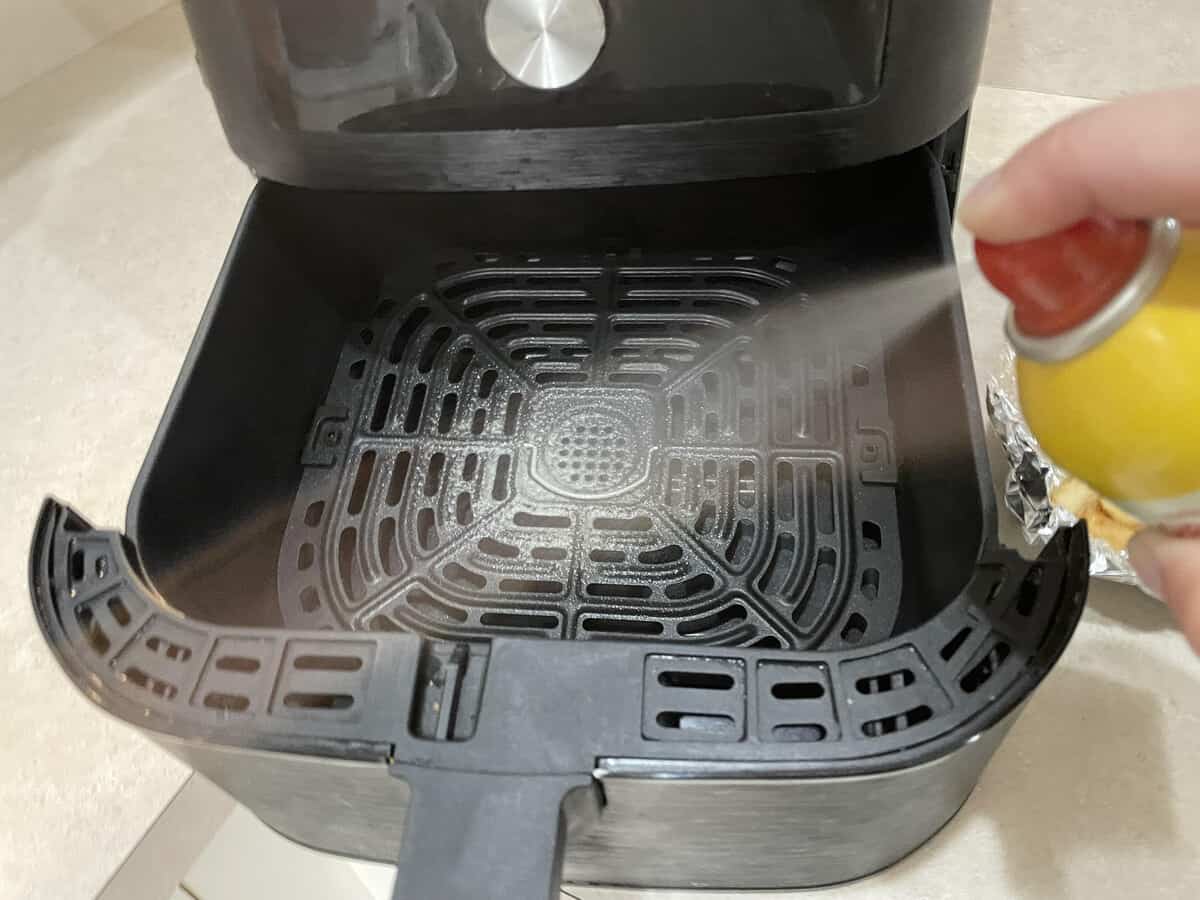 spray air fryer basket with cooking oil