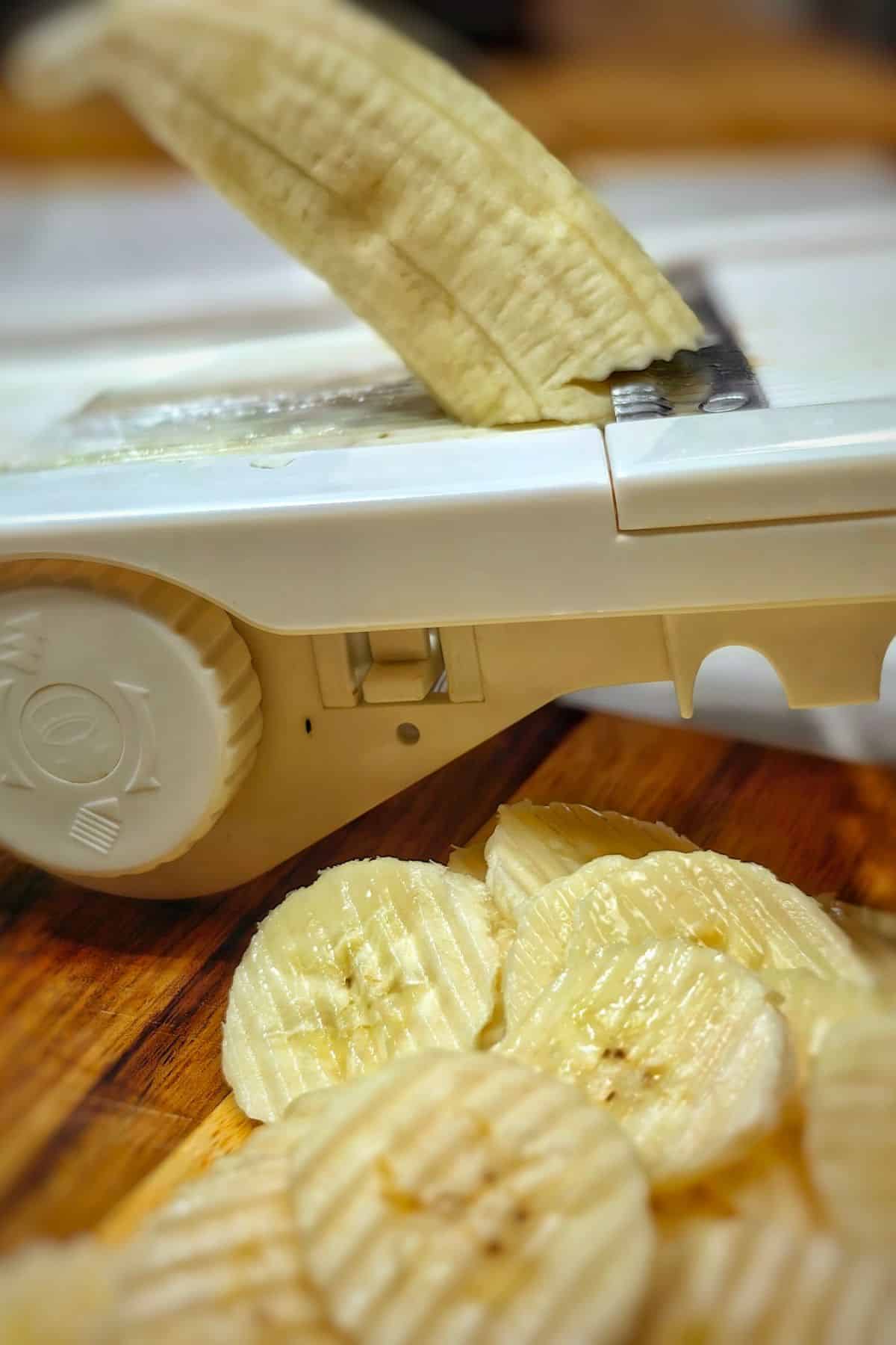 Banana being sliced on Mandoline