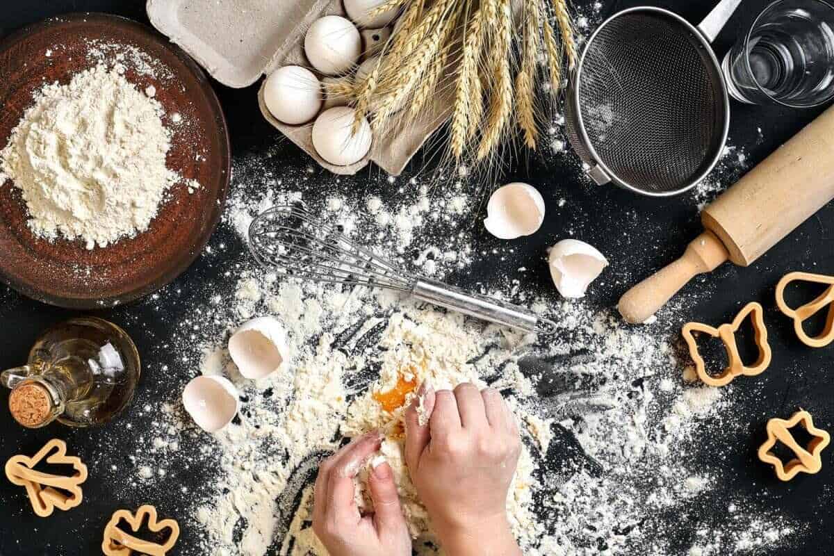 flour, eggs and other ingredients on black table