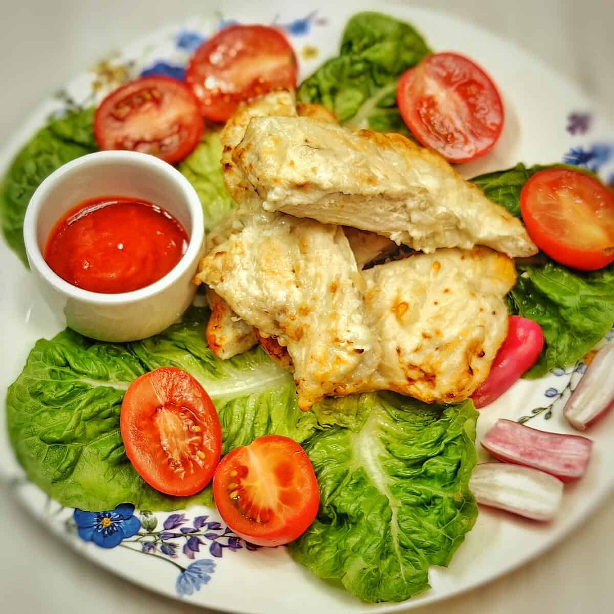 air fried chicken breast with sliced tomatoes, radish, and lettuce