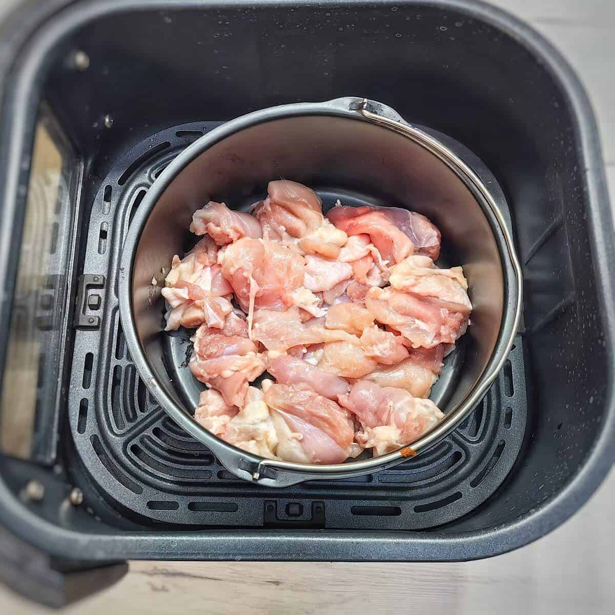 chicken in a metal container suitable inside air fryer
