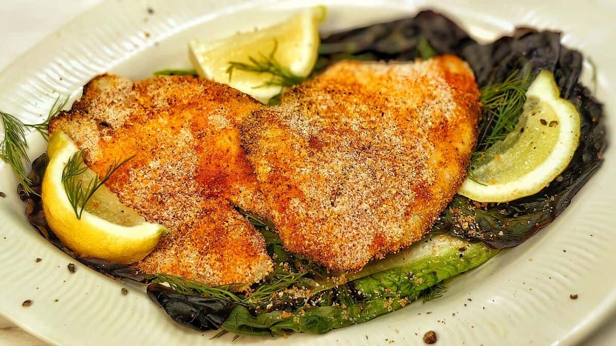 air fried tilapia on a plate with lemon slices