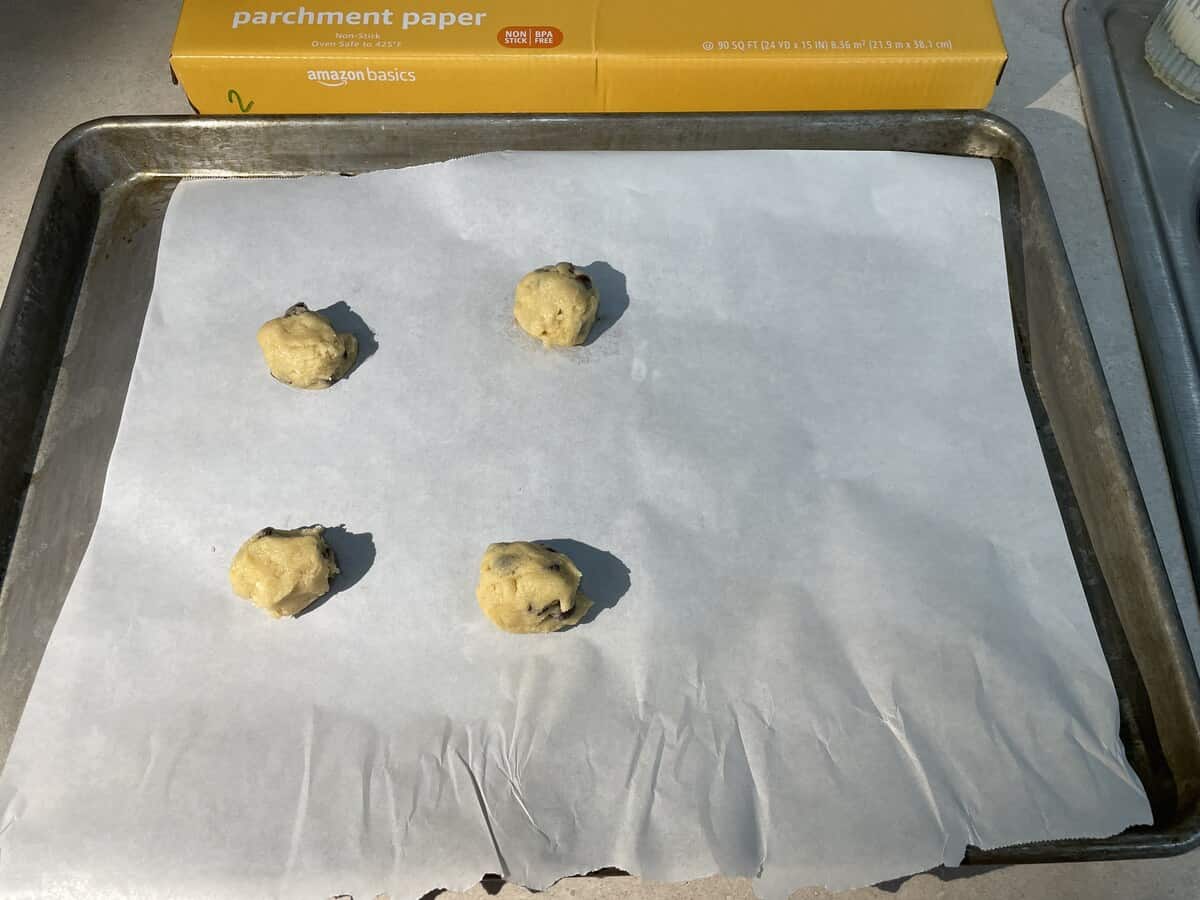 cookie dough balls on top of amazon basics parchment paper