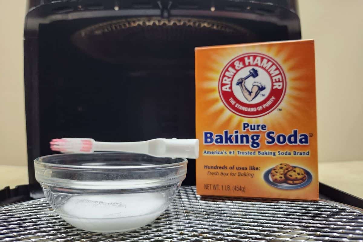 baking soda and toothbrush in front of an air fryer