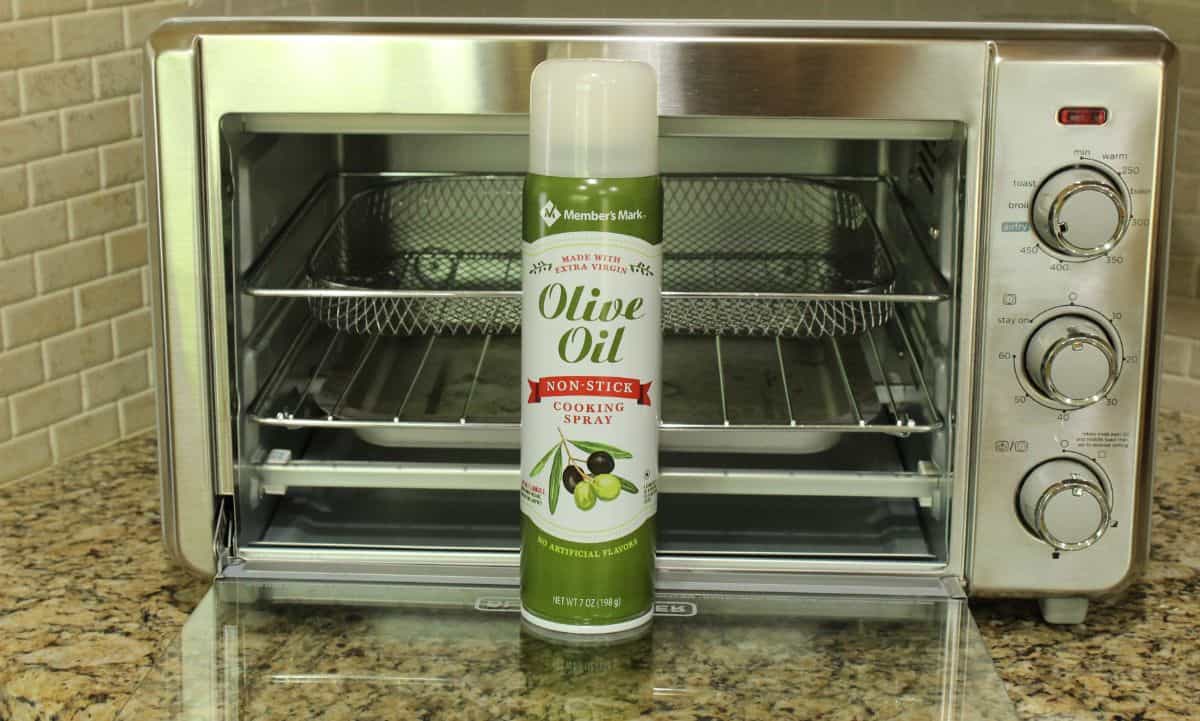 olive oil spray in front of oven air fryer