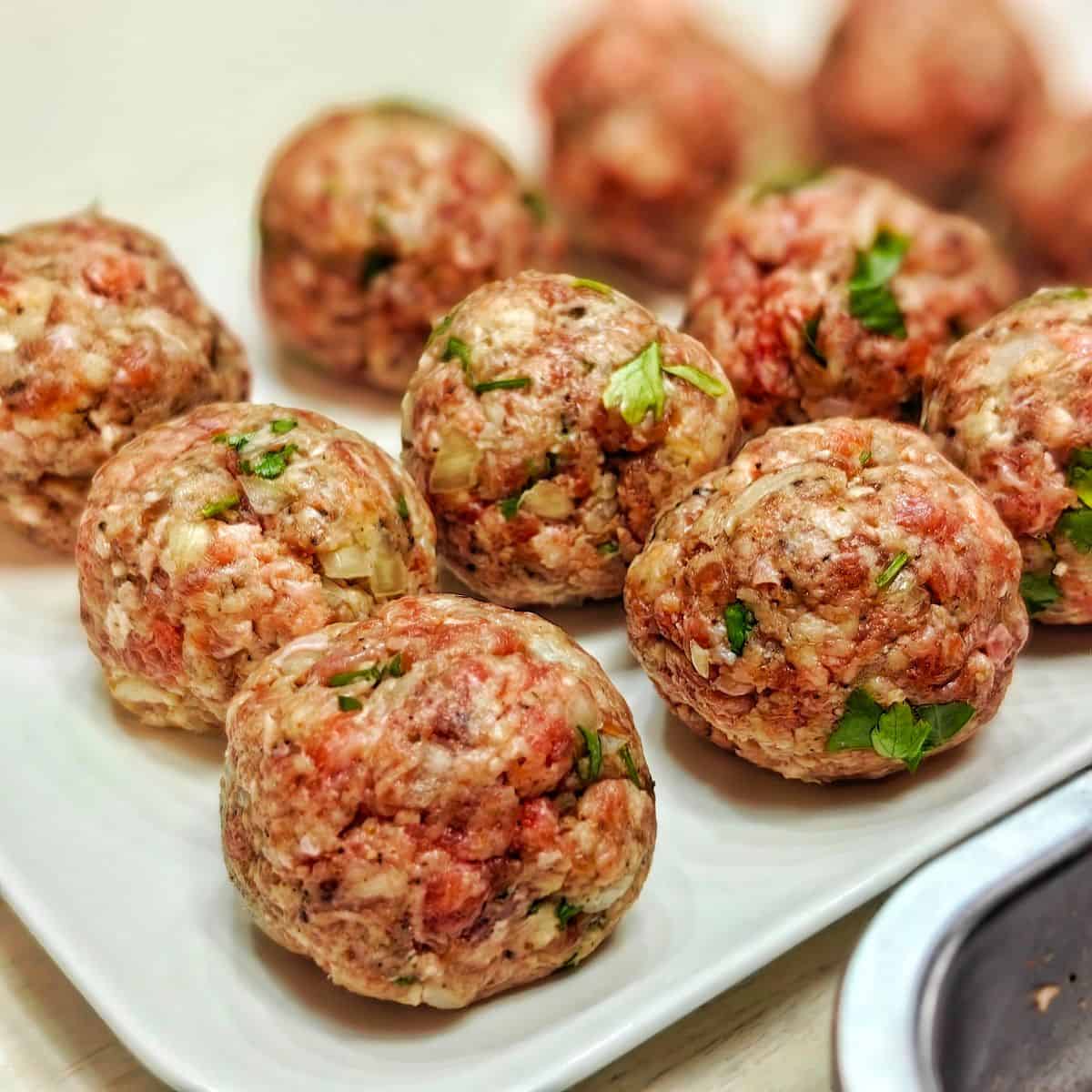 raw meatballs on a plate