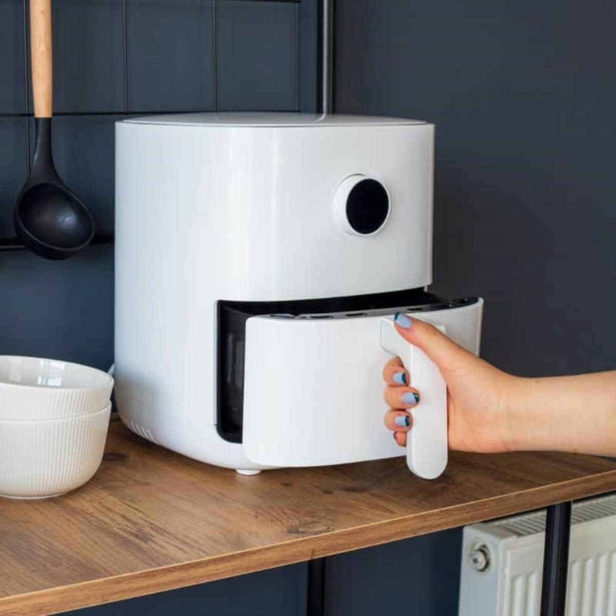 white air fryer with hand opening basket