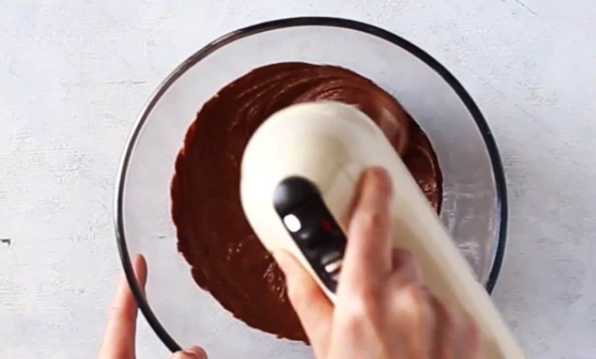 mixing chocolate batter with hand mixer