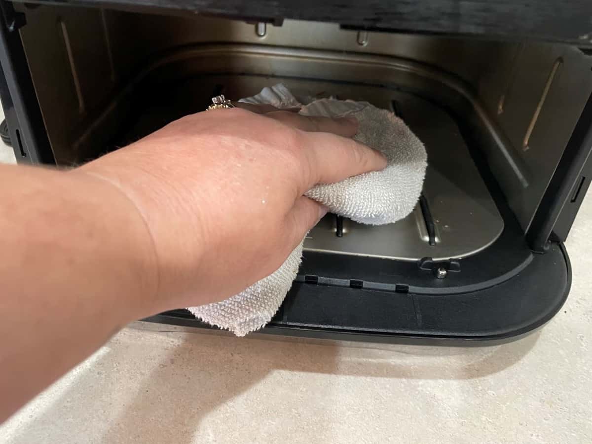 wiping inside of air fryer