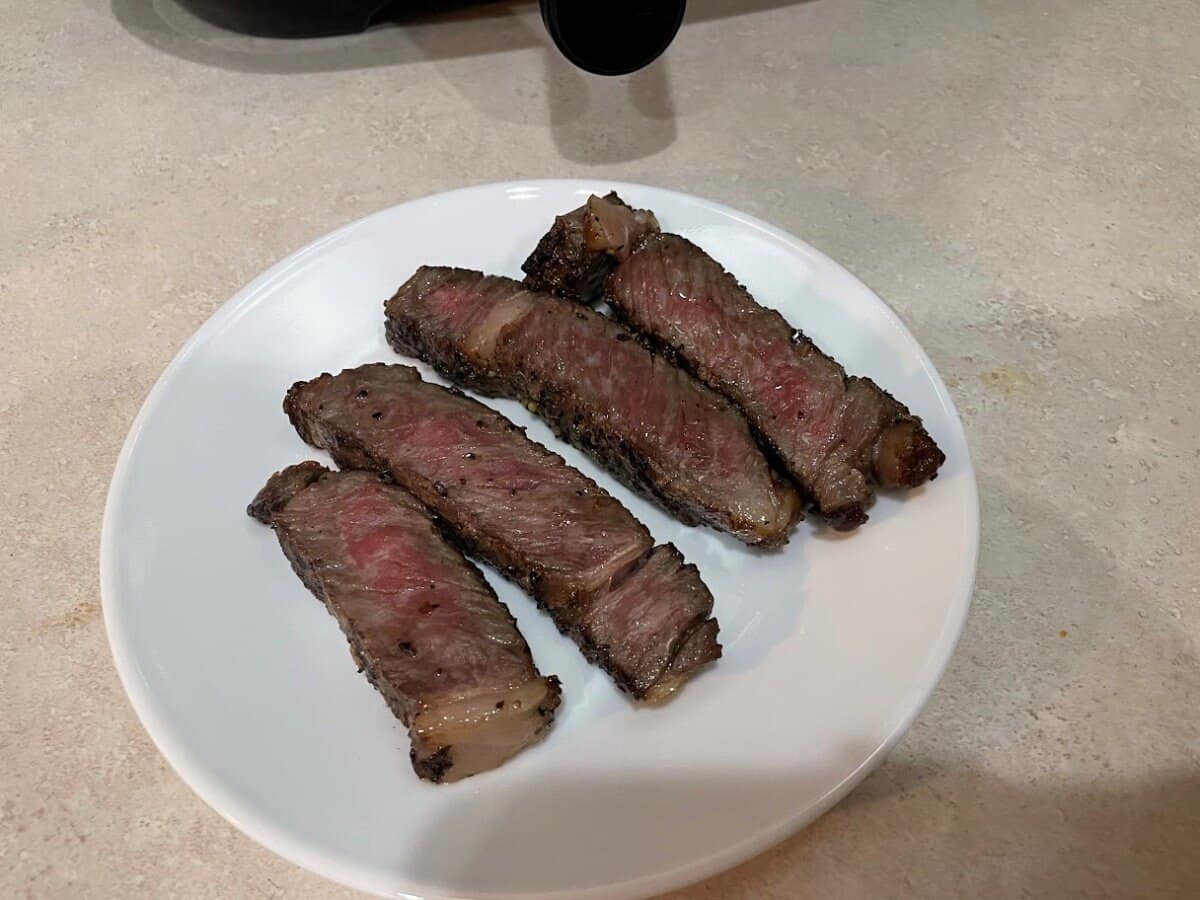 air fried steak on a white plate
