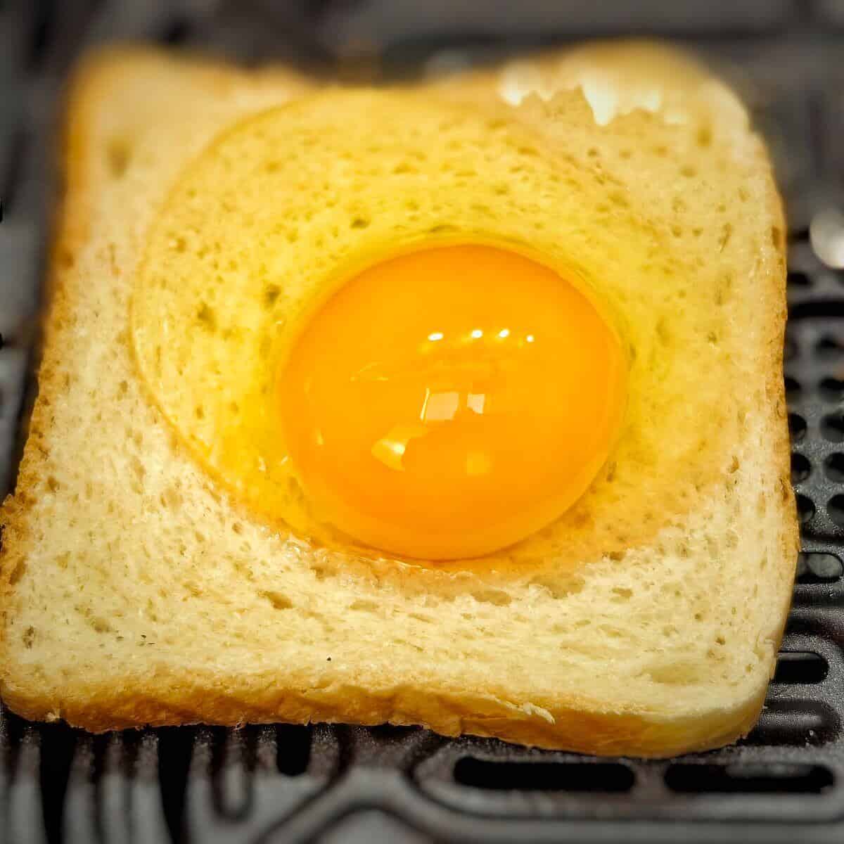 raw egg on top of sliced white bread