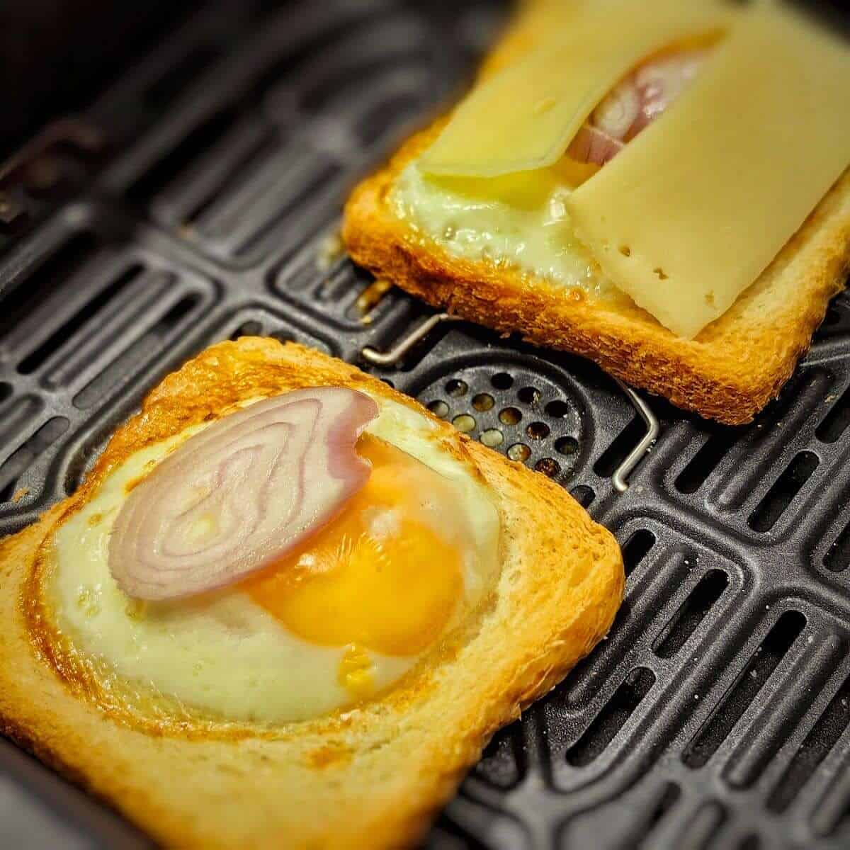 cheese and slice shallot on top of egg on sliced bread