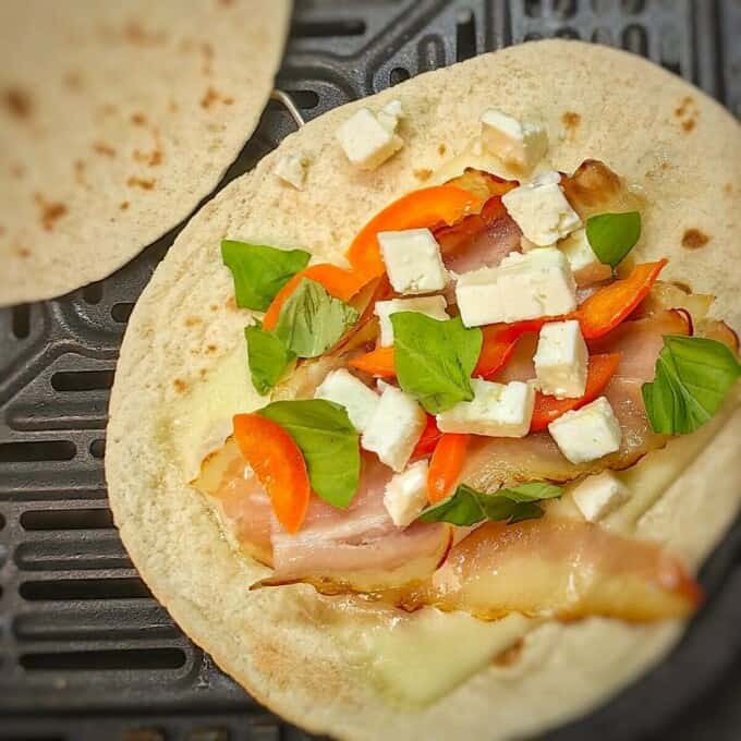 close up shot of tortilla with cheese and vegetables