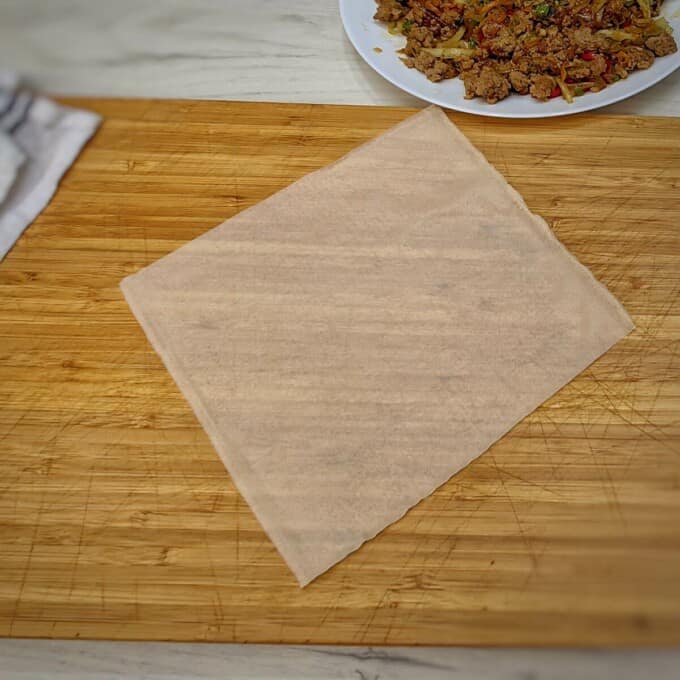 1 piece of egg roll wrapper on a chopping board