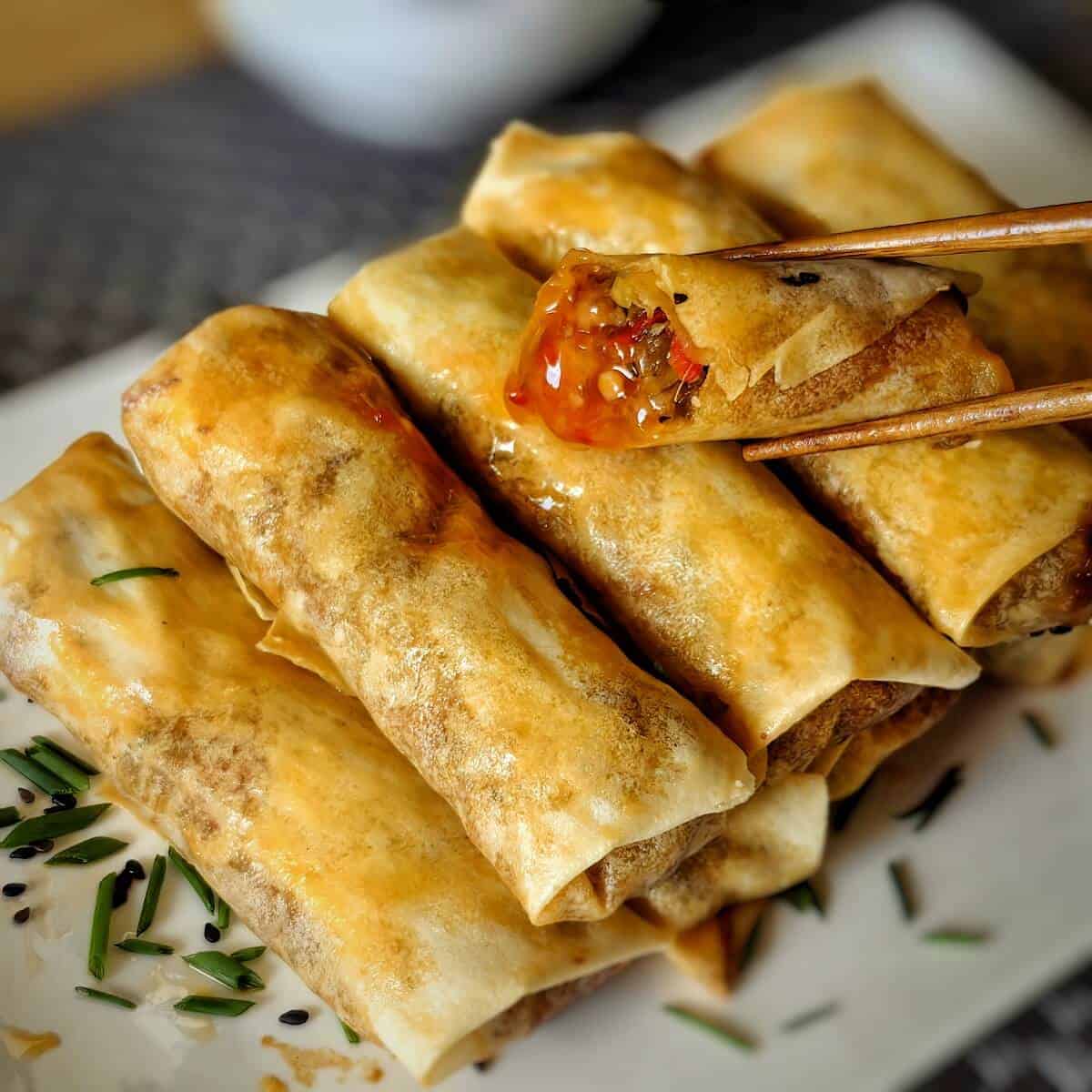 air fried egg roll with chili sauce on a serving plate