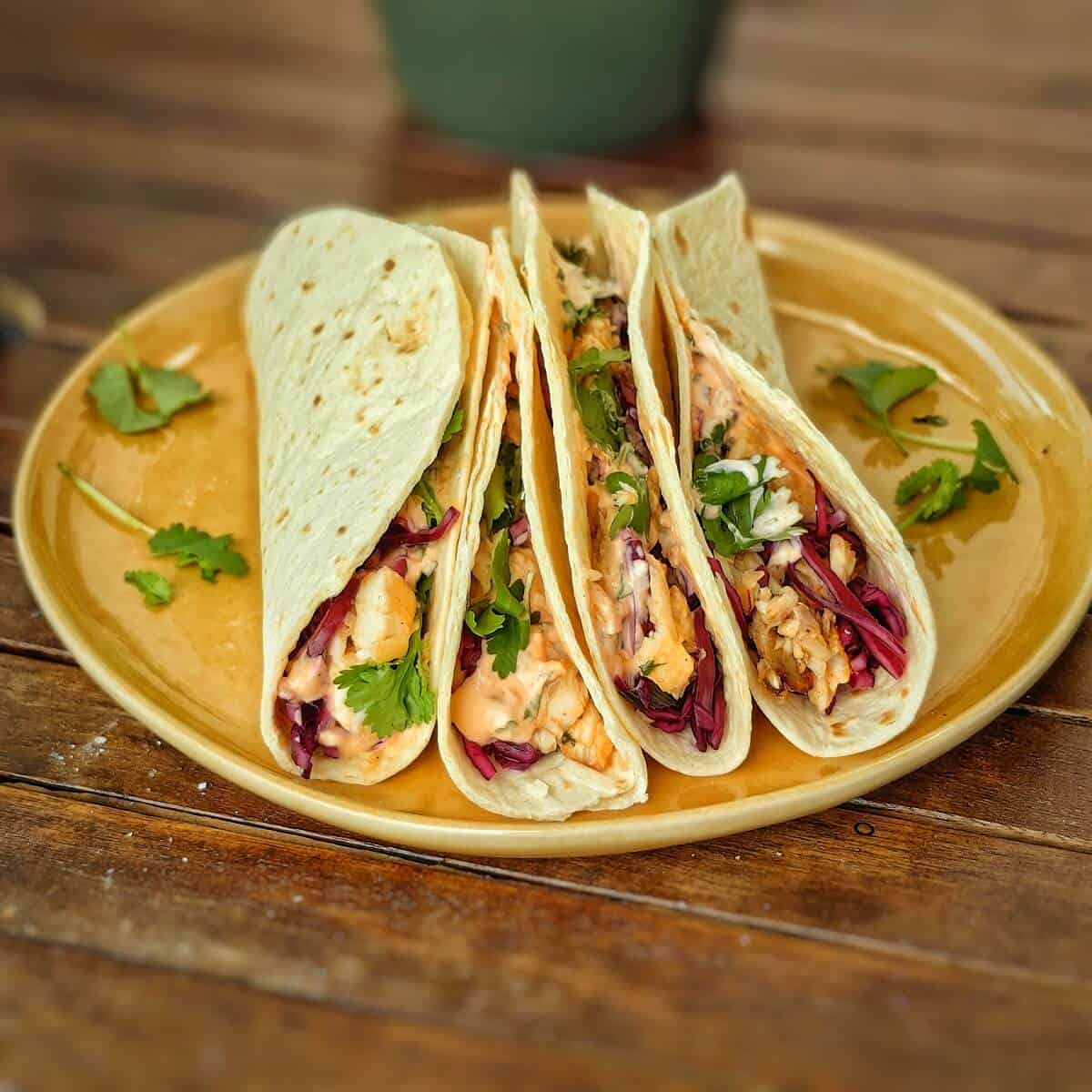 air fryer fish tacos on a yellow plate