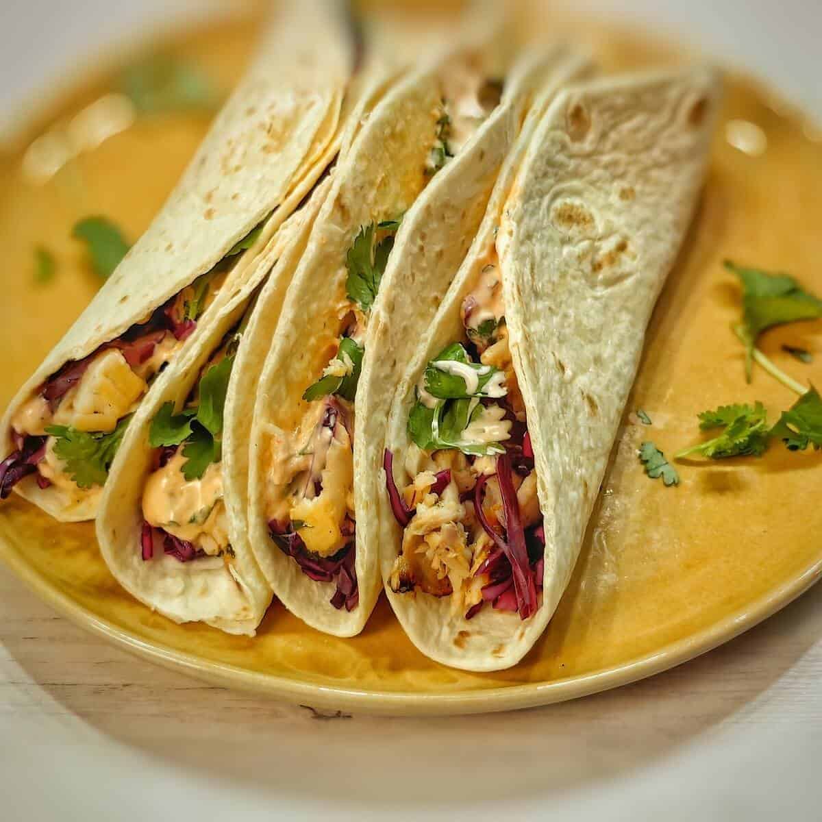 air fryer fish tacos on a brown plate