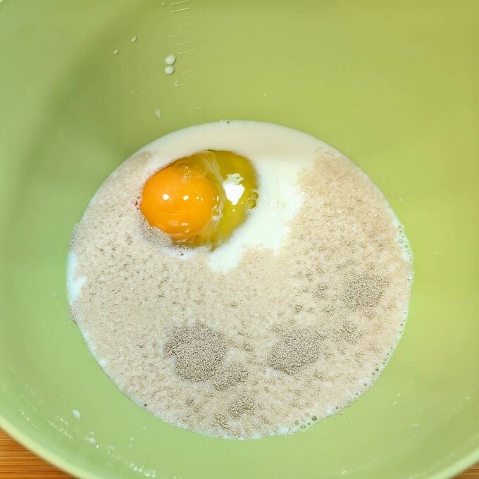 egg, milk, sugar and yeast in mixing bowl