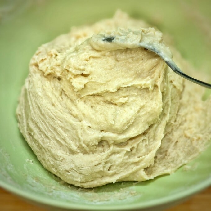 wet dough in a green mixing bowl