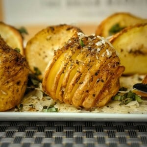 air fryer hasselback potatoes on a white serving plate