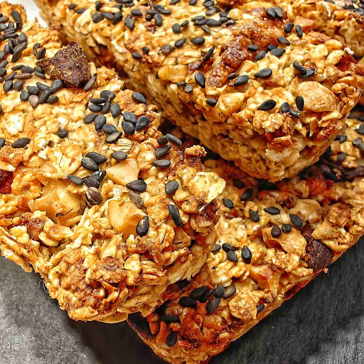 close up shot of air fryer oatmeal breakfast bars on a black serving plate