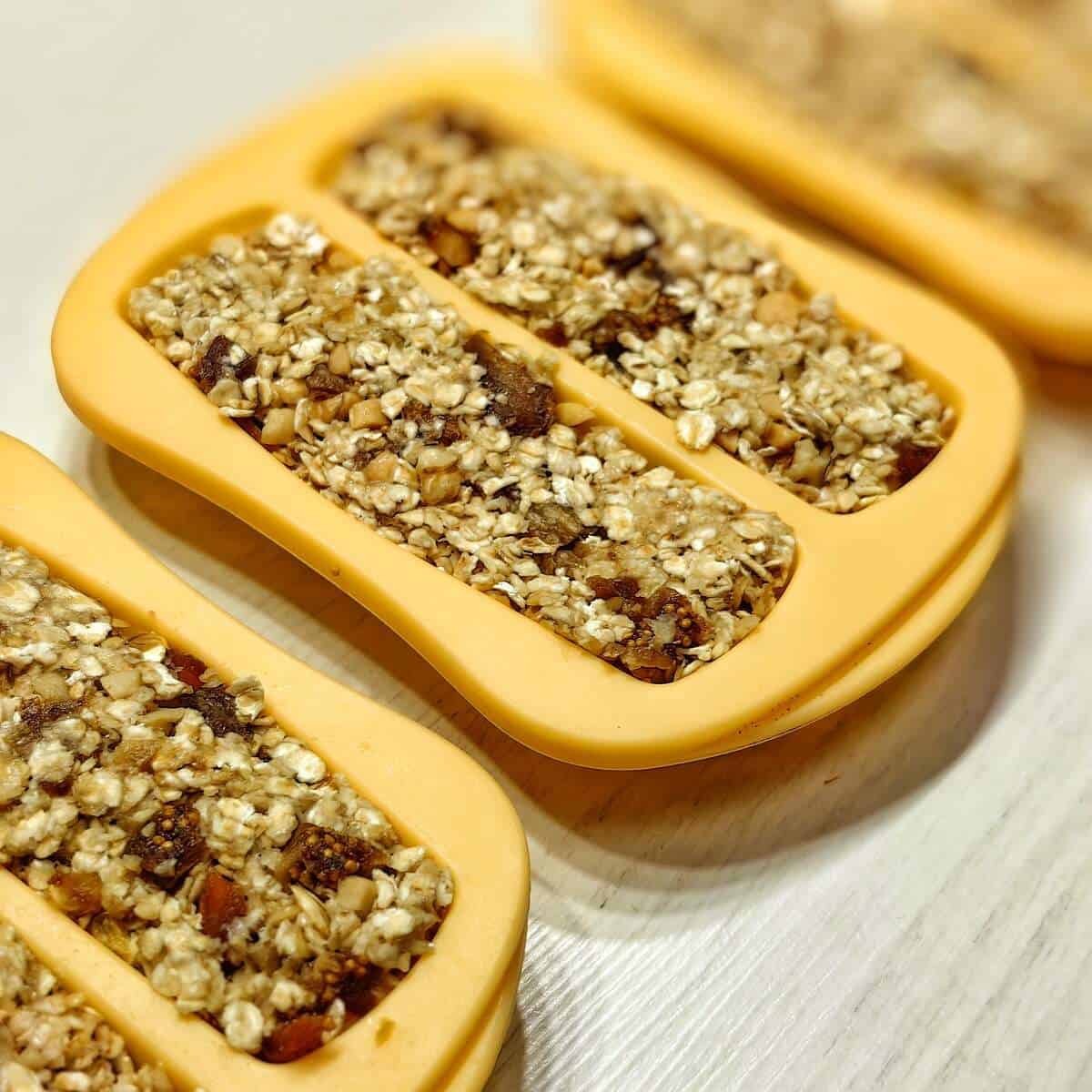 mixture for oatmeal breakfast bars in a yellow silicone mold