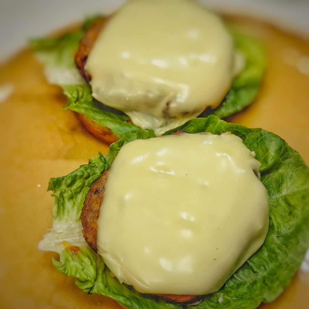 air fryer turkey burgers with cheese on top of lettuce