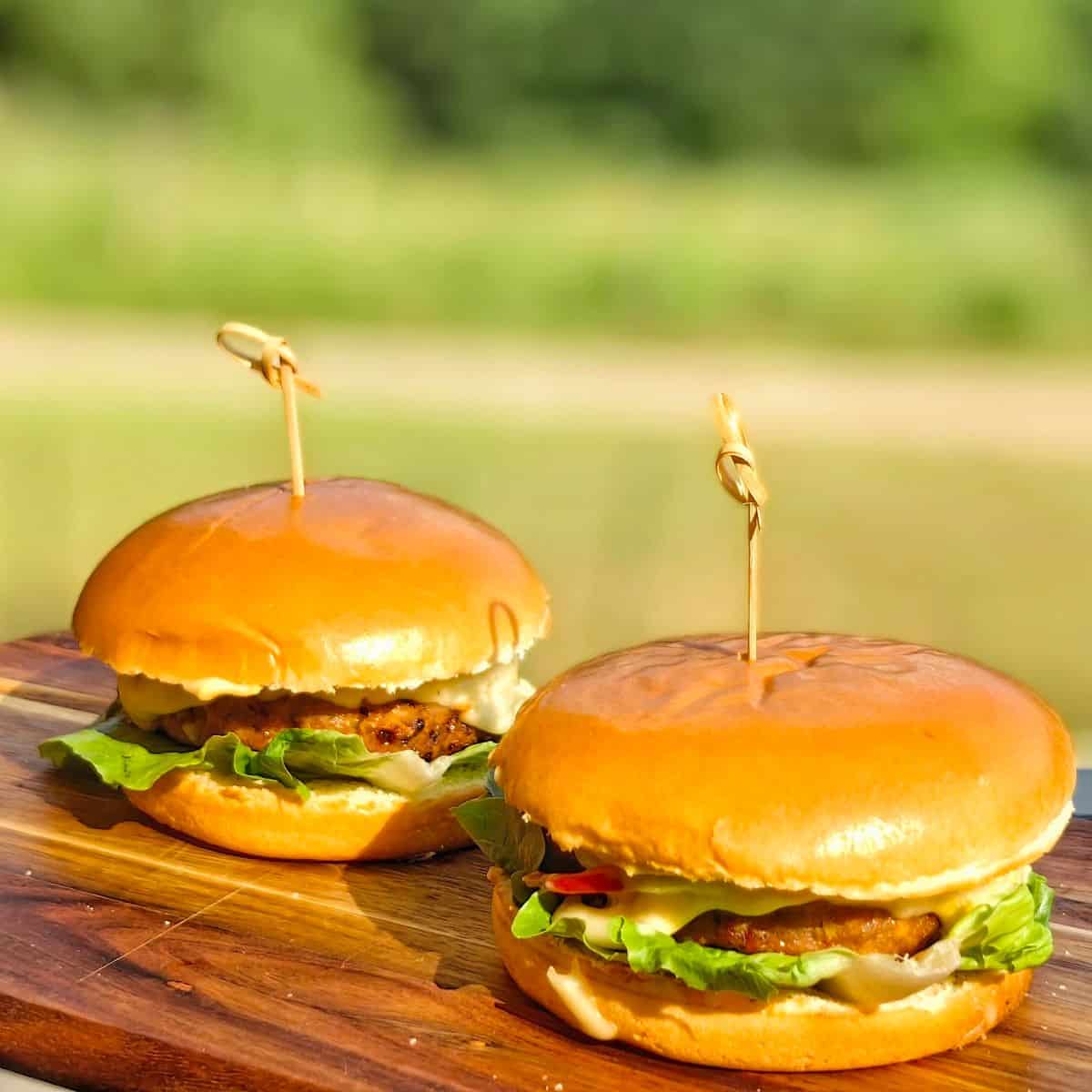 air fryer turkey burgers on a wooden chopping board outdoors