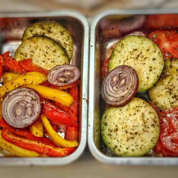 sliced vegetables with herbs and spices in rectangular metal containers