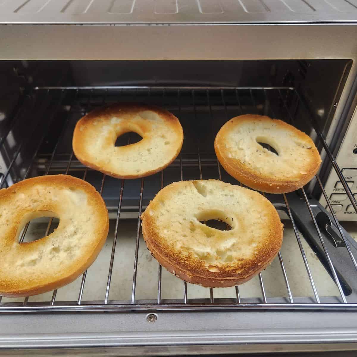 four bagels in an air fryer oven