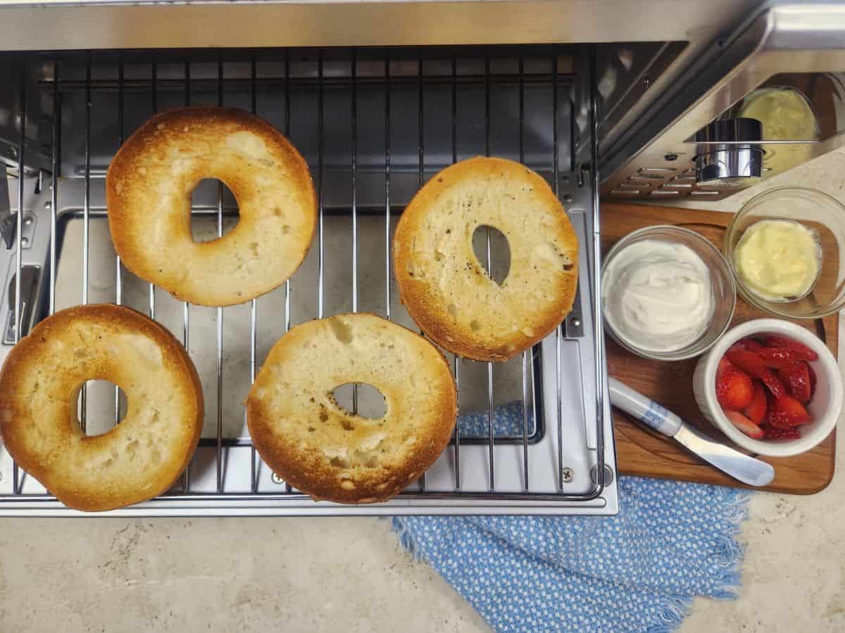air fried bagels beside cream cheese, jam and cheese spread