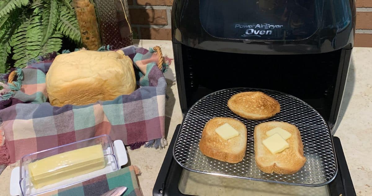 bread in an air fryer with butter on the side a loaf of bread