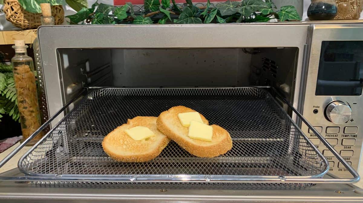 bread in an oven with slices of butter