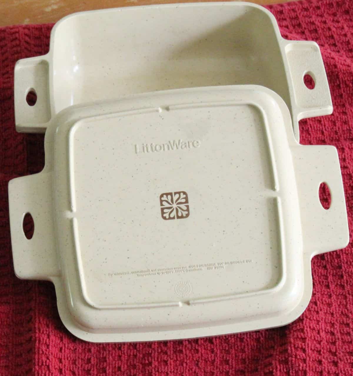 Littonware casserole on top of red kitchen towel