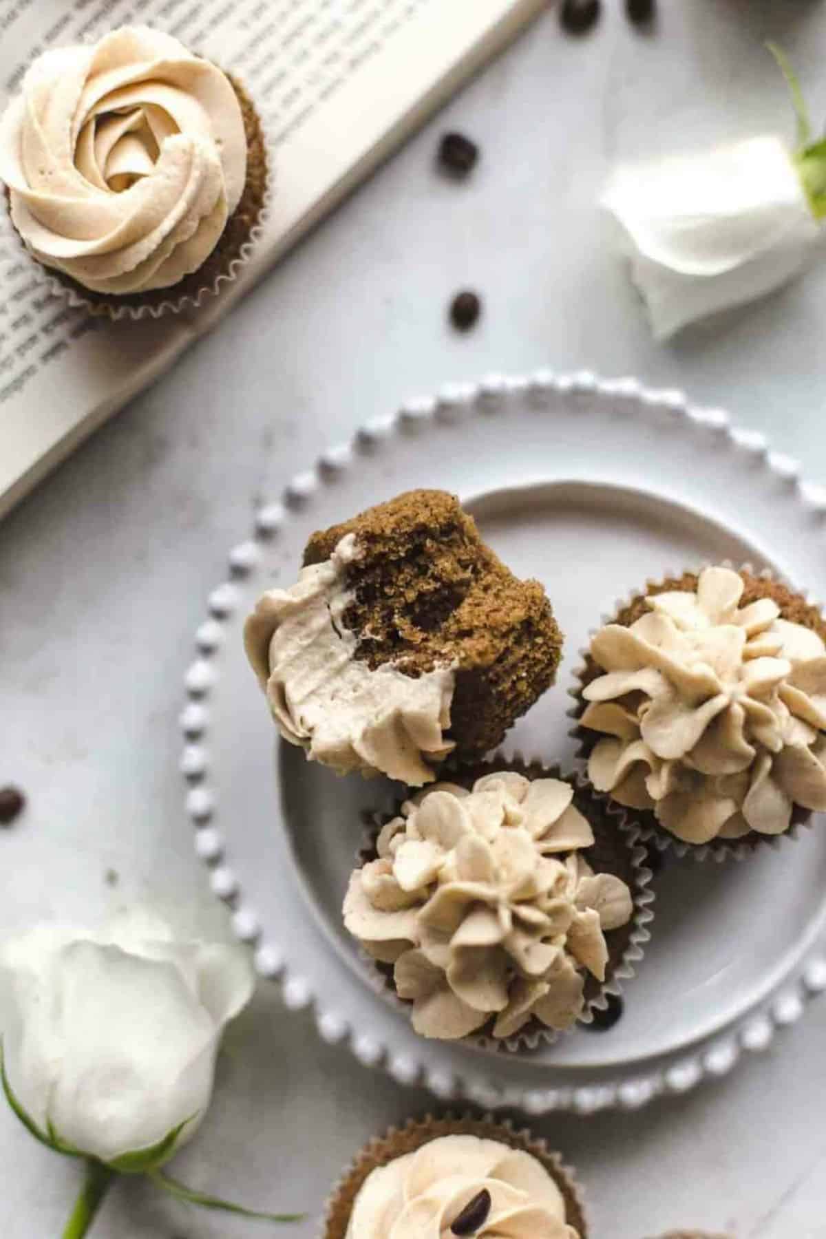 coffee cupcakes with frosting on a white plate