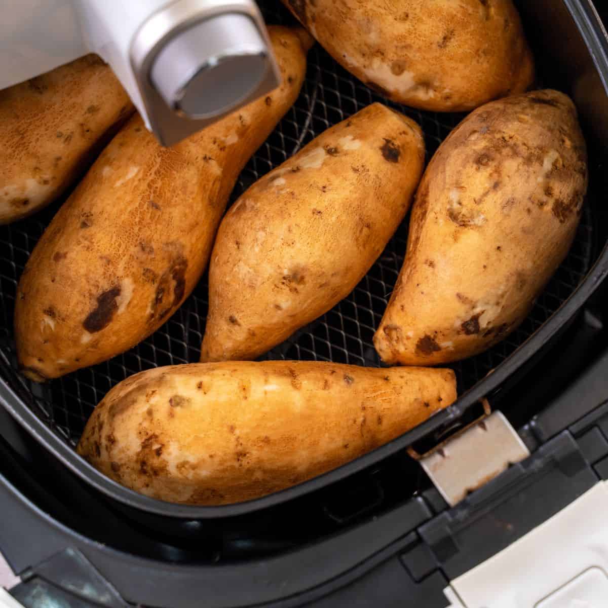 sweet potatoes inside air fryer basket