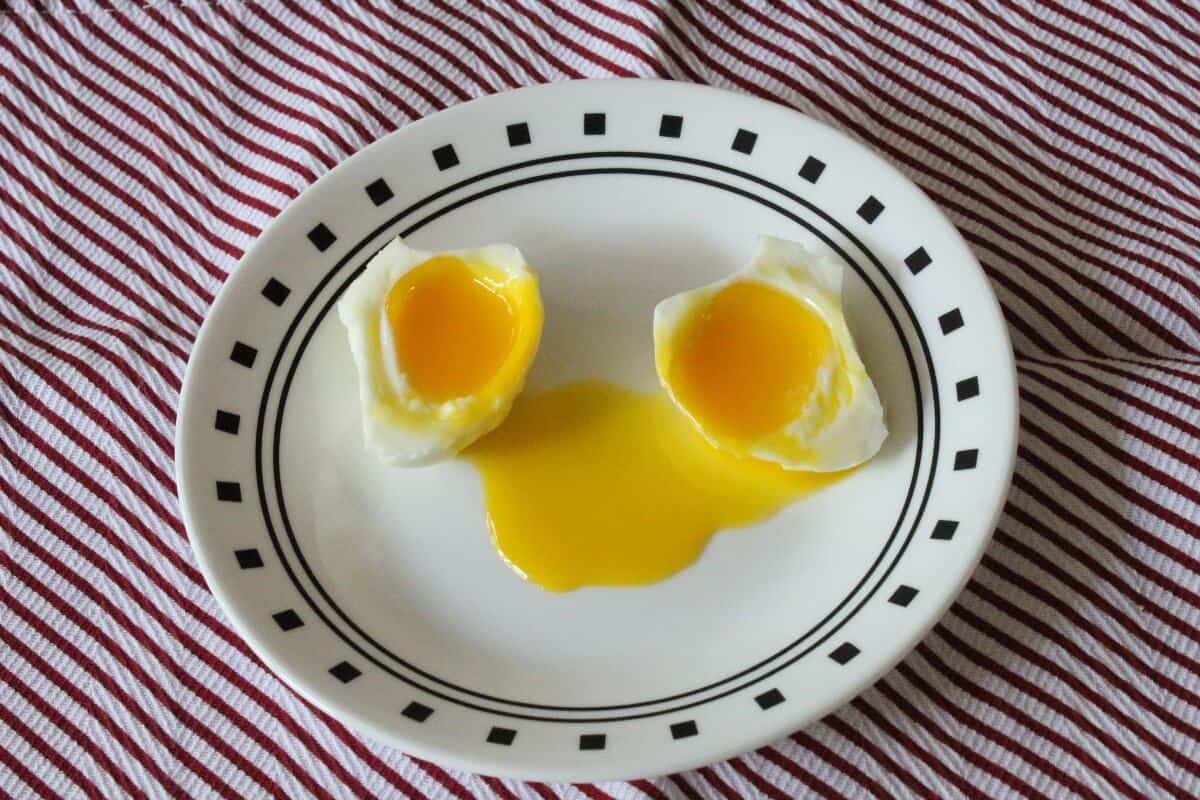 eggs with runny yolk on a serving plate