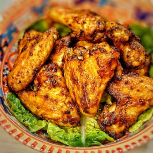 air fryer bbq chiken wings on a bed of greens