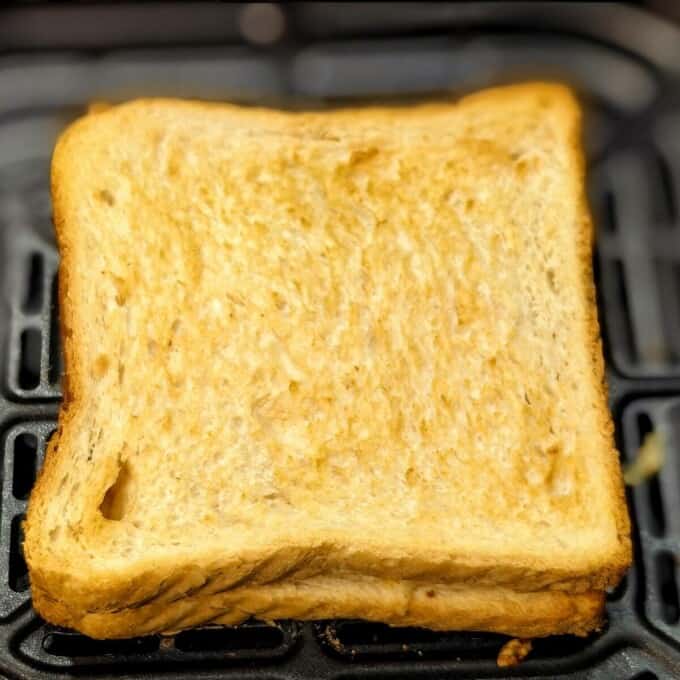 2 toasted slices of bread in air fryer basket