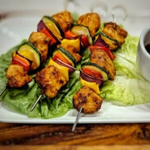 air fryer chicken kabobs on a bed of lettuce