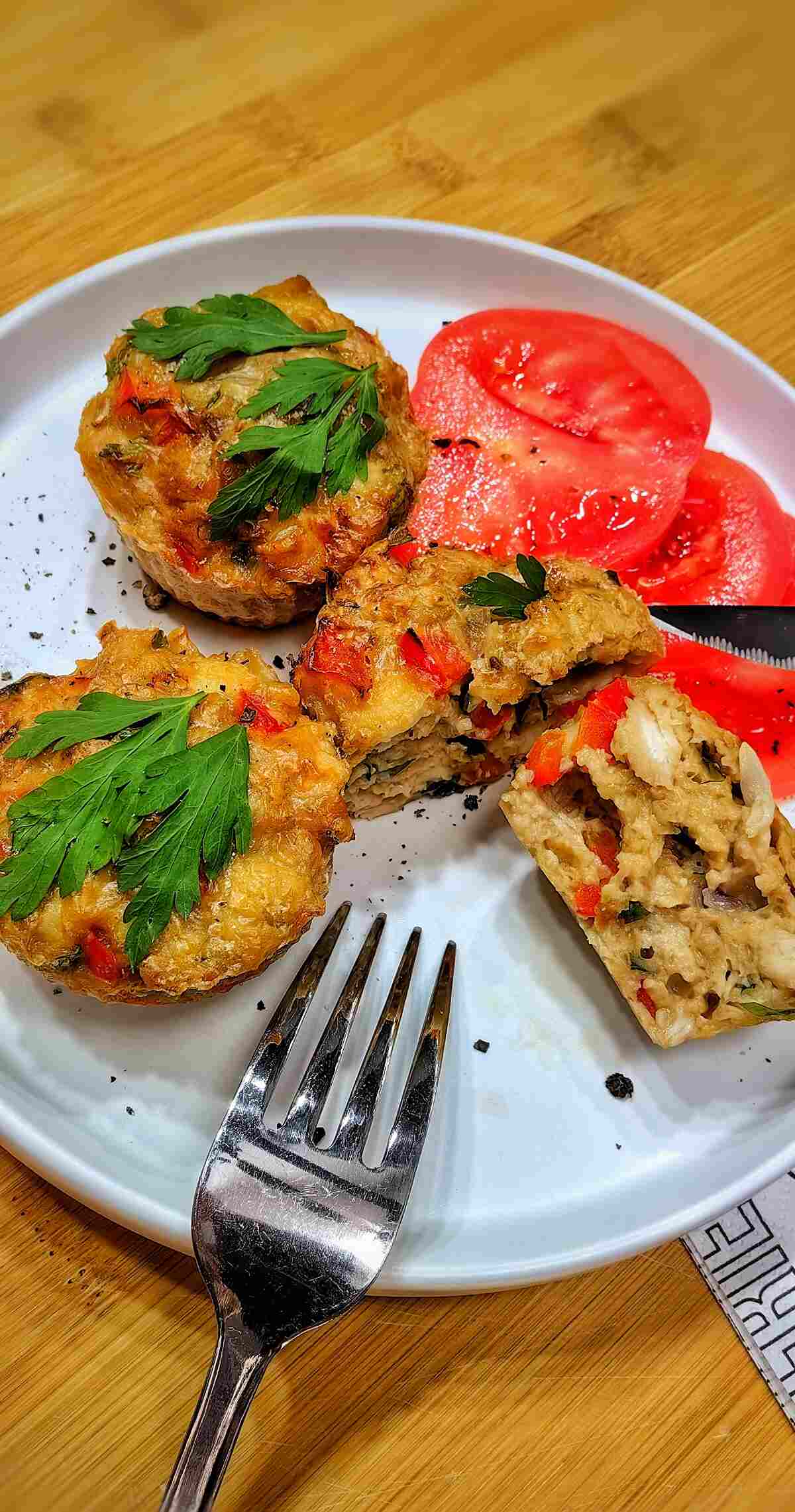 air fryer chicken muffins with tomatoes on a white plate