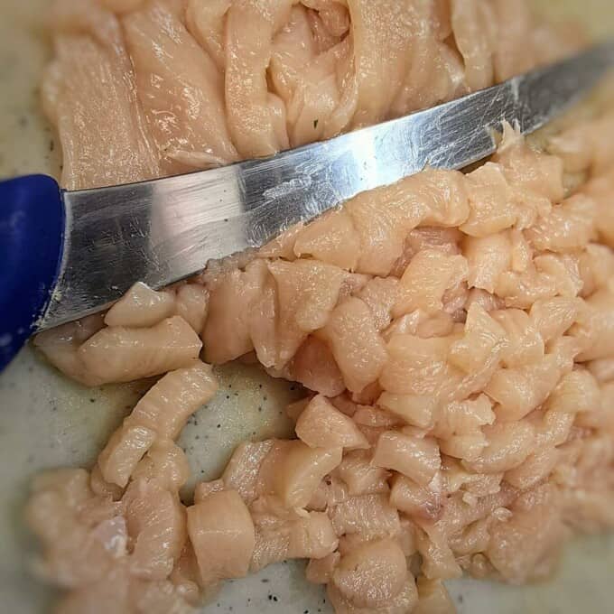 diced chicken with knife