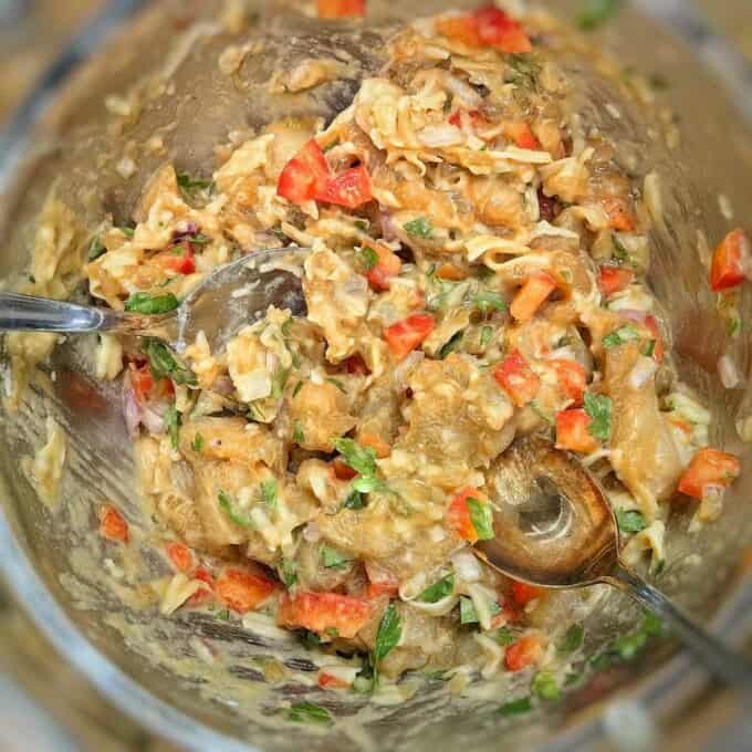 mixed diced chicken and chopped vegetables in metal mixing bowl