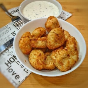 air fryer frozen chicken nuggets with a bowl of homemade ranch dressing