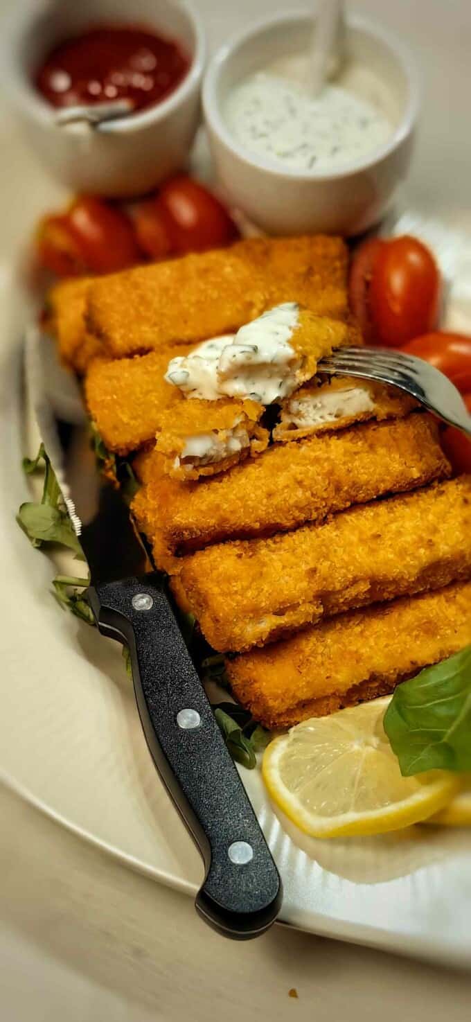 air fryer frozen fish sticks on a serving plate with ranch dip