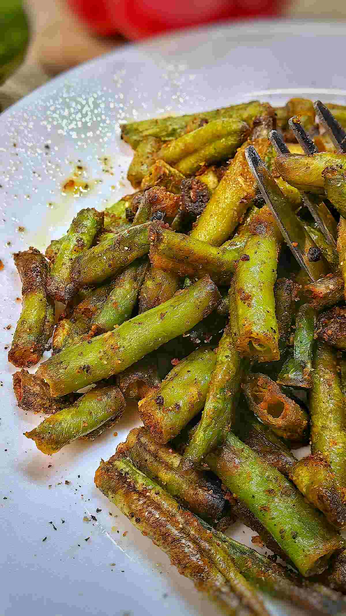 air fried frozen green beans on a serving plate with fork