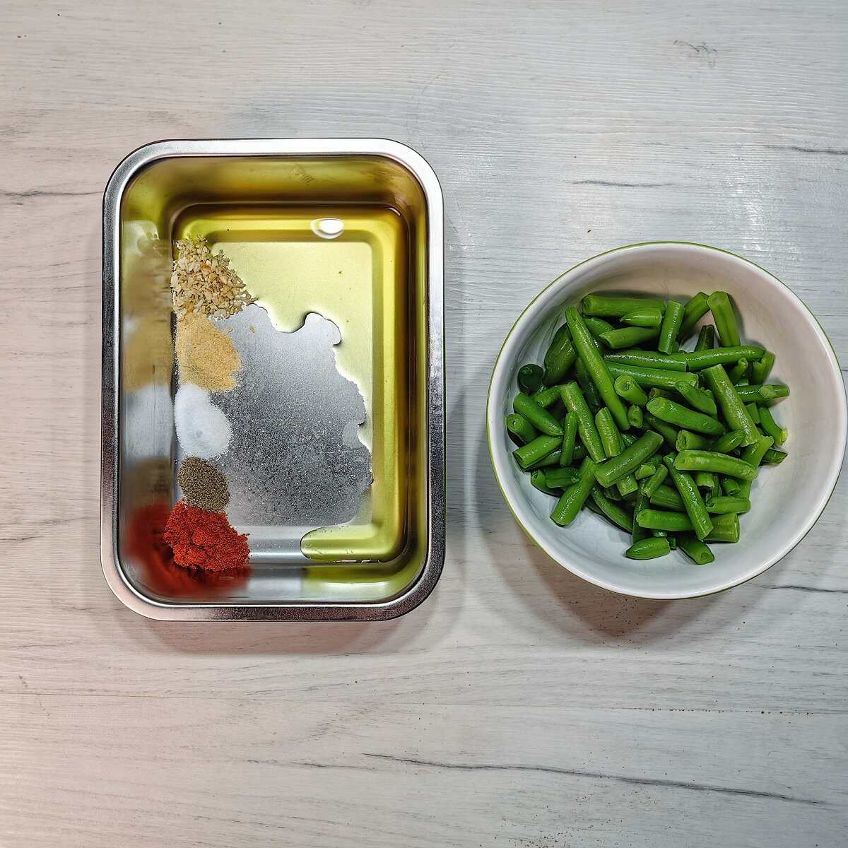 bowl of green beens and metal bowl with spices