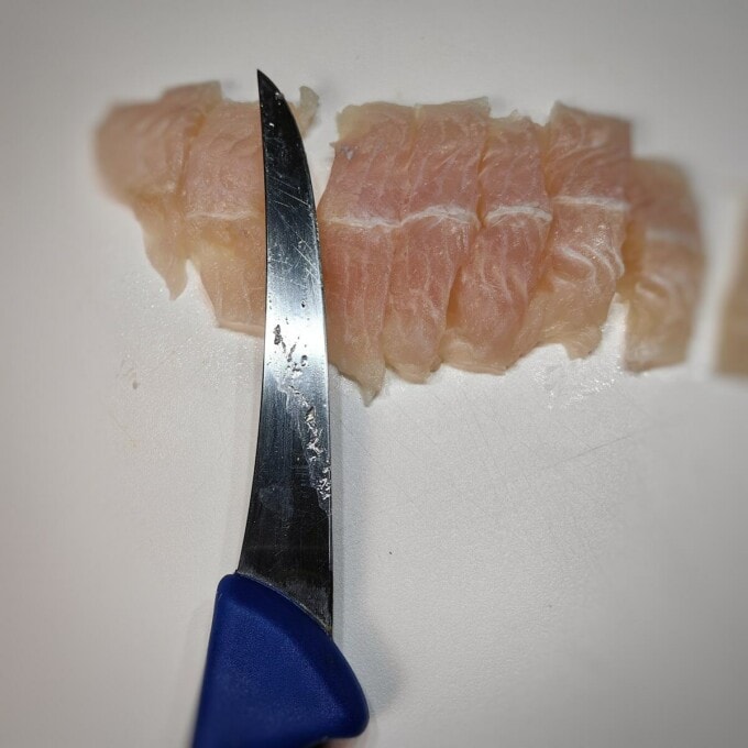 sliced fish fillet with knife