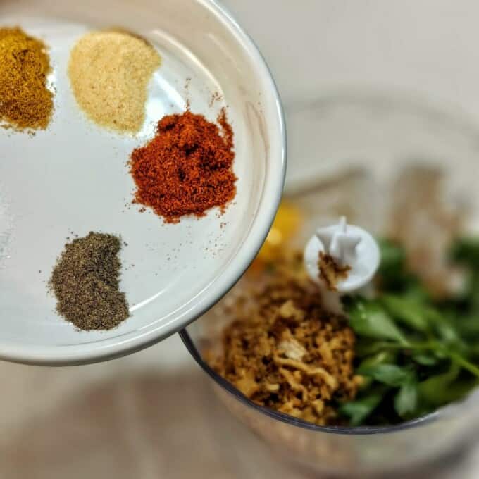food processor and plate with herbs and spices